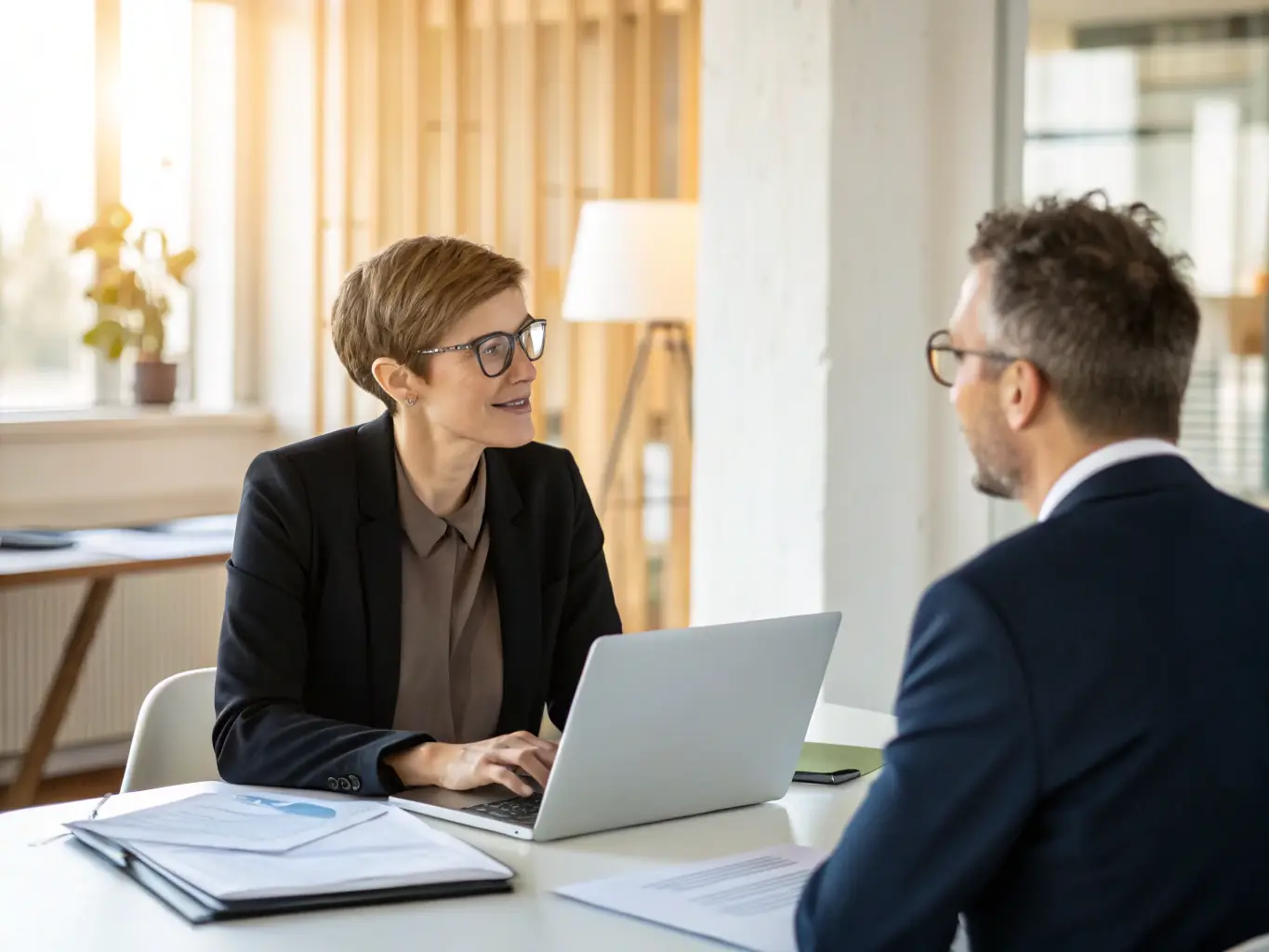A professional interview scene with a recruiter and a candidate in an office setting, representing recruitment and executive search services.