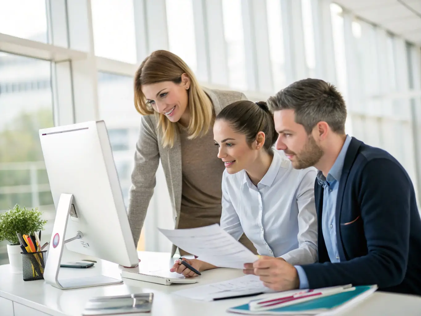 A team working on payroll and HR tasks, illustrating P&O's outsourcing solutions.